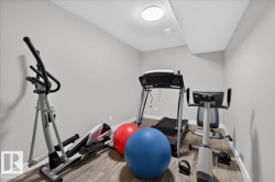 Dedicated room featuring wood-finish flooring, recessed lighting, and a white ceiling - 