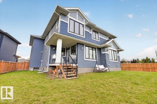 Modern two-story home featuring blue fiber cement siding, gabled roofline with architectural detail, and multi-pane windows - 6813 Knox Loop Sw, Edmonton, AB - Outdoor