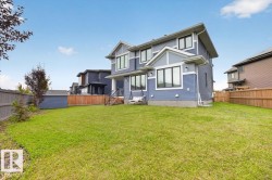 Expansive green space with wood fencing - 