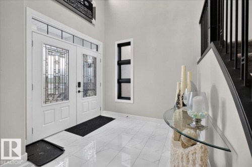 Double entry doors with decorative glass panels and transom window - 6813 Knox Loop Sw, Edmonton, AB - Indoor Photo Showing Other Room