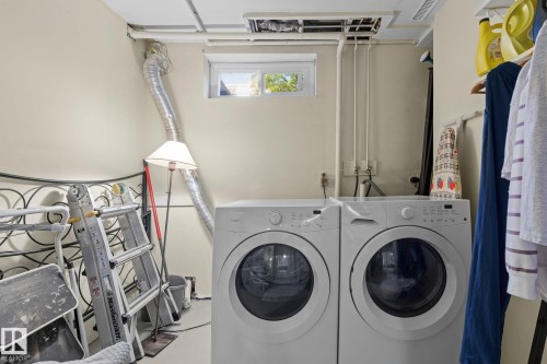 Laundry area with a pair of front-loading appliances and a built-in window - 17132 103 Street Nw, Edmonton, AB 