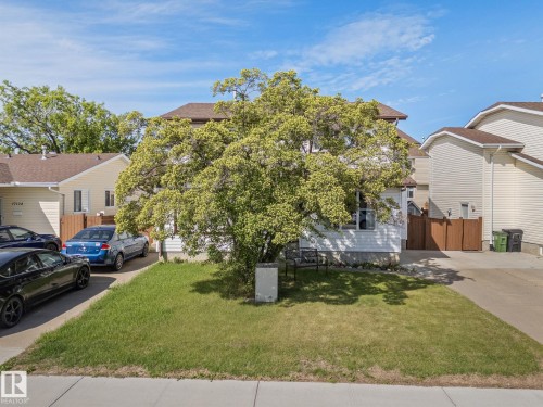 Front exterior with siding, a mature tree, and a driveway - 17132 103 Street Nw, Edmonton, AB 