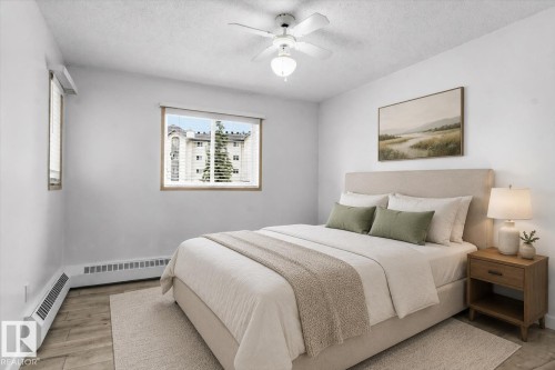 Wood-finish flooring with a textured area rug - #102 6710 158 Av Nw, Edmonton, AB 
