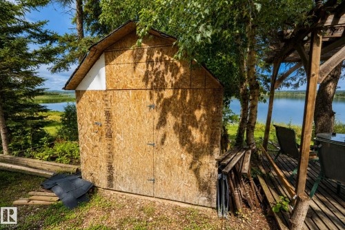 Wood-sided shed with an asphalt shingle roof - 506 60017 Range Road 110 A, Rural St. Paul County, AB 
