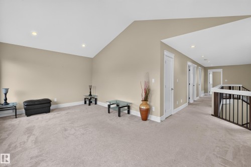 Carpeted loft area with vaulted ceiling, recessed lighting, and white trim - 7014 Chivers Loop Sw, Edmonton, AB 