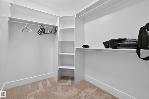 Built-in closet system with shelving and hanging rods - 7014 Chivers Loop Sw, Edmonton, AB 