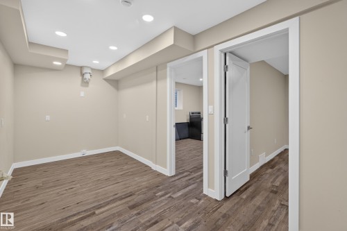 Recessed lighting, wood-finish flooring, light neutral wall color, and white trim - 7014 Chivers Loop Sw, Edmonton, AB 