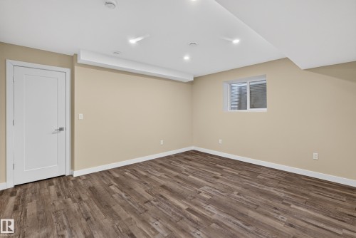 Recessed lighting, wood-finish flooring, white trim, and a window with blinds - 7014 Chivers Loop Sw, Edmonton, AB 