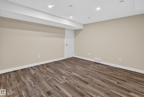 Recessed lighting, wood-finish flooring, light neutral wall paint, and white trim - 7014 Chivers Loop Sw, Edmonton, AB 