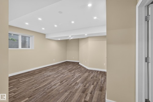 Recessed lighting, wood-finish flooring, neutral paint palette, and white trim - 7014 Chivers Loop Sw, Edmonton, AB 