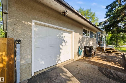 Attached garage with white panel door - 5208 105 Street Nw, Edmonton, AB - Outdoor With Exterior