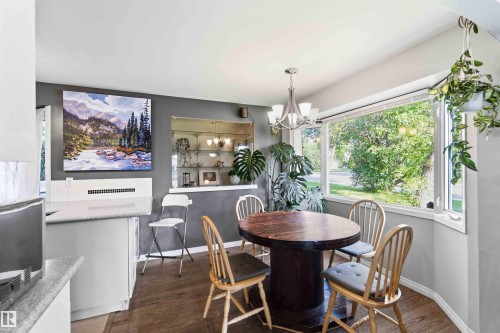 Dining area featuring wood-finish flooring and a bay window - 5208 105 Street Nw, Edmonton, AB - Indoor Photo Showing Dining Room