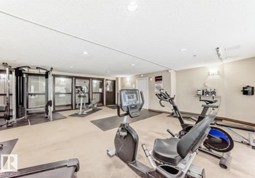 Fitness center featuring cardio equipment, strength training machines, and recessed lighting - #1418 330 Clareview Station Dr Nw, Edmonton, AB - Indoor Photo Showing Gym Room