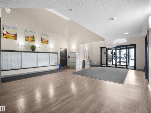 Wood-finish flooring throughout the common area - #1418 330 Clareview Station Dr Nw, Edmonton, AB - Indoor Photo Showing Other Room