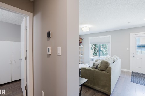 Interior hallway featuring a smart thermostat and light-colored walls - #28 2215 24 St Nw, Edmonton, AB - Indoor Photo Showing Other Room