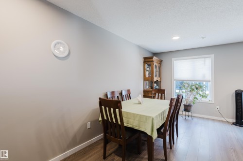 Dining area featuring wood-finish flooring, a window with a roller shade, and recessed ceiling lighting - #28 2215 24 St Nw, Edmonton, AB - Indoor Photo Showing Dining Room