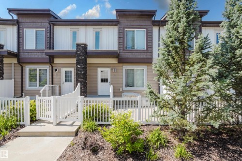 Modern townhouse facade featuring horizontal siding and vertical paneling accents - #28 2215 24 St Nw, Edmonton, AB - Outdoor With Facade