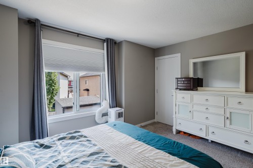 Interior room with neutral gray wall paint and textured carpet flooring - #28 2215 24 St Nw, Edmonton, AB - Indoor Photo Showing Bedroom