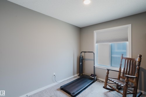 Recessed ceiling lighting illuminates a room with light grey walls and light grey carpet - #28 2215 24 St Nw, Edmonton, AB - Indoor