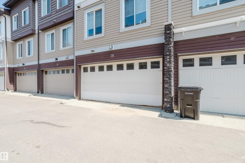 Townhome exterior featuring light-colored horizontal siding and dark brown accent panels - #28 2215 24 St Nw, Edmonton, AB - Outdoor With Exterior