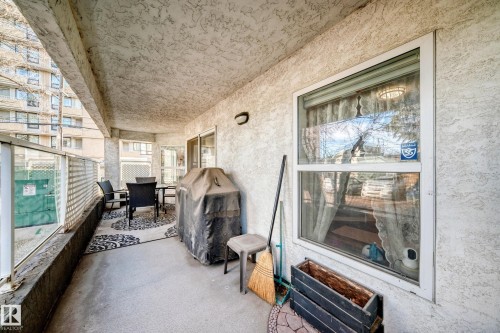 Balcony featuring concrete flooring and a stucco ceiling - #108 12028 103 Av Nw, Edmonton, AB 
