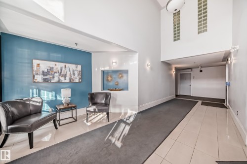 Entryway featuring a two-story ceiling, recessed wall niche, and tile flooring - #108 12028 103 Av Nw, Edmonton, AB 