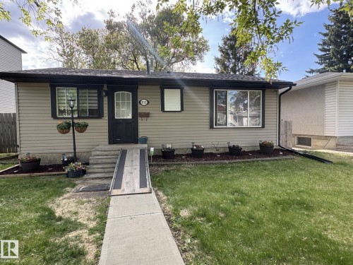 Single-story residence featuring light-colored siding and dark trim - 10312 154 Street Nw, Edmonton, AB 