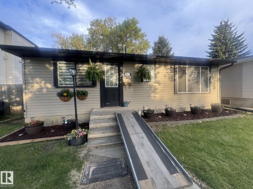 Beige horizontal siding with black trim accents - 10312 154 Street Nw, Edmonton, AB 