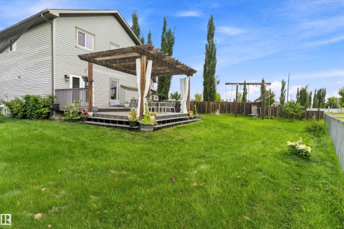 Spacious lawn area with a chain-link perimeter fence - 20845 92A Avenue Nw, Edmonton, AB - Outdoor