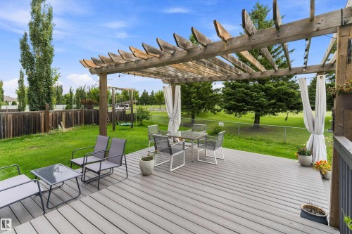 Expansive backyard featuring a composite deck, a wooden pergola, and a manicured lawn - 20845 92A Avenue Nw, Edmonton, AB - Outdoor With Deck Patio Veranda With Backyard
