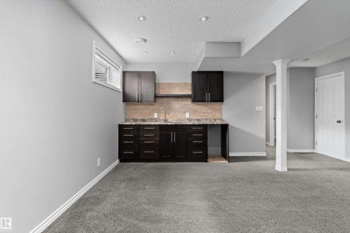 Recessed lighting, light gray wall paint, dark wood-finish cabinetry, built-in sink, and light gray carpeting - 20845 92A Avenue Nw, Edmonton, AB - Indoor