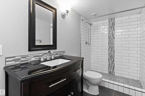 Dark wood-finish vanity with an undermount sink - 20845 92A Avenue Nw, Edmonton, AB - Indoor Photo Showing Bathroom