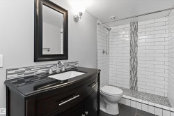 Dark wood-finish vanity with an undermount sink - 