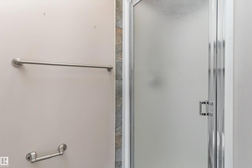 Enclosed shower with a frosted glass door and a chrome handle - 20845 92A Avenue Nw, Edmonton, AB - Indoor Photo Showing Bathroom