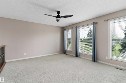 Expansive room featuring multiple windows, neutral wall tones, and a ceiling fan - 20845 92A Avenue Nw, Edmonton, AB - Indoor Photo Showing Other Room