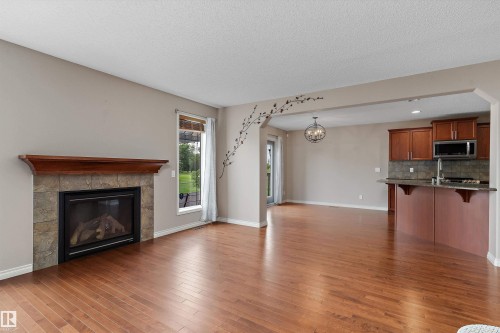 Hardwood-style flooring throughout - 20845 92A Avenue Nw, Edmonton, AB - Indoor Photo Showing Other Room With Fireplace