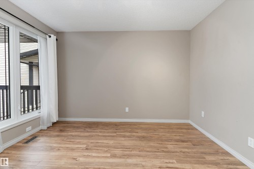 Wood-finish flooring with neutral wall paint and white trim - 20845 92A Avenue Nw, Edmonton, AB - Indoor Photo Showing Other Room