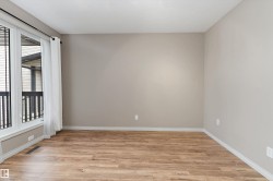 Wood-finish flooring with neutral wall paint and white trim - 