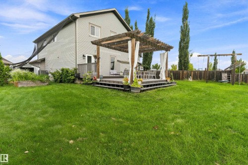 Spacious backyard with a raised wood deck, a wood pergola, and a privacy fence - 20845 92A Avenue Nw, Edmonton, AB - Outdoor