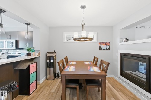 187 Radcliffe Wynd, Fort Saskatchewan, AB - Indoor Photo Showing Dining Room With Fireplace