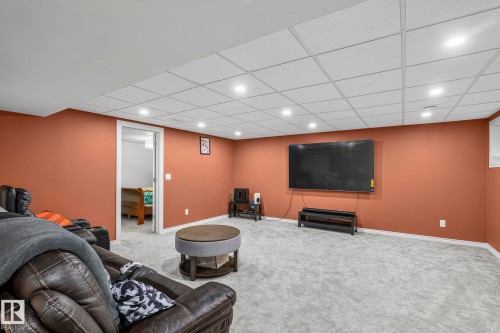 Recessed lighting, wall-mounted television, drop ceiling, and light-colored carpeting - 923 174St Sw, Edmonton, AB 