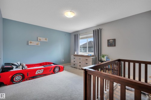 Recessed window with drapes, flush mount ceiling light, and light-toned carpet - 17321 8A Avenue Sw, Edmonton, AB - Indoor Photo Showing Bedroom
