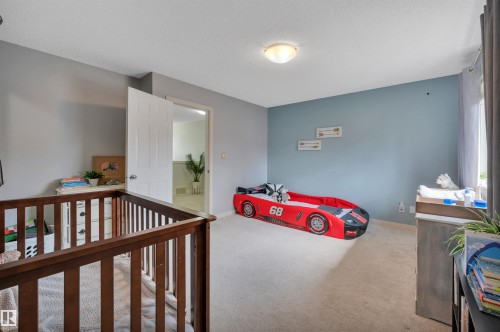 Wall-to-wall carpeting, overhead lighting, neutral wall tones, and a bright white interior door - 17321 8A Avenue Sw, Edmonton, AB - Indoor Photo Showing Other Room