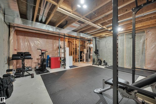 Unfinished basement with exposed ceiling joists, concrete walls, and a concrete floor - 17321 8A Avenue Sw, Edmonton, AB - Indoor Photo Showing Basement