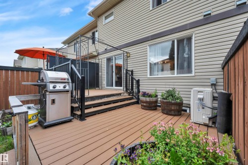 Expansive composite deck featuring a privacy fence, multi-level design, and direct access to the interior via sliding glass doors - 17321 8A Avenue Sw, Edmonton, AB - Outdoor With Deck Patio Veranda With Exterior