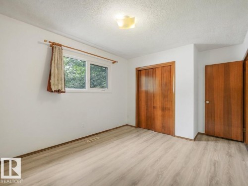 Light wood-finish flooring, white walls, and a multi-pane window - 16428 88 Avenue Nw, Edmonton, AB - Indoor Photo Showing Other Room