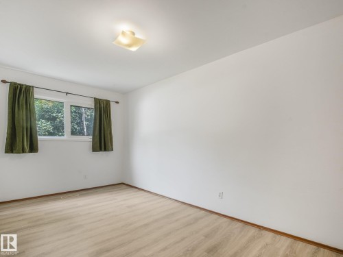 Wood-finish flooring with white walls - 16428 88 Avenue Nw, Edmonton, AB - Indoor Photo Showing Other Room