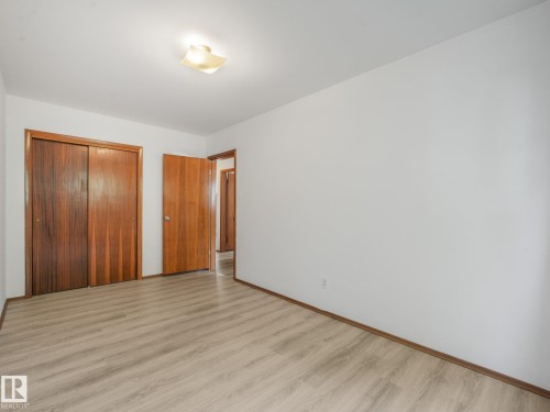 Wood-finish flooring, white walls, and a ceiling-mounted light fixture - 16428 88 Avenue Nw, Edmonton, AB - Indoor Photo Showing Other Room