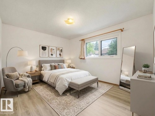 Light wood-finish flooring with white walls and a large window - 16428 88 Avenue Nw, Edmonton, AB - Indoor Photo Showing Bedroom