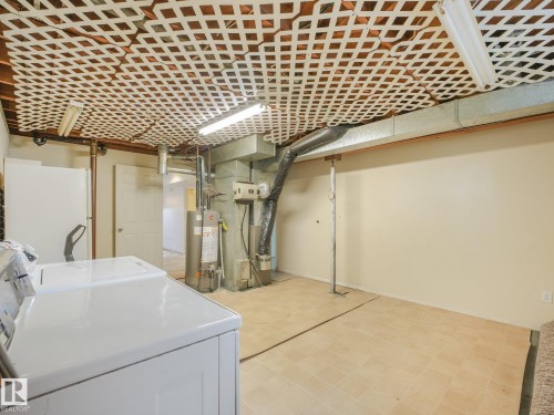 Utility room with tile flooring and exposed ceiling beams - 16428 88 Avenue Nw, Edmonton, AB - Indoor